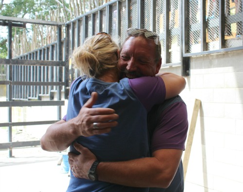 Zoo staff embrace after Tisa successfully stands up